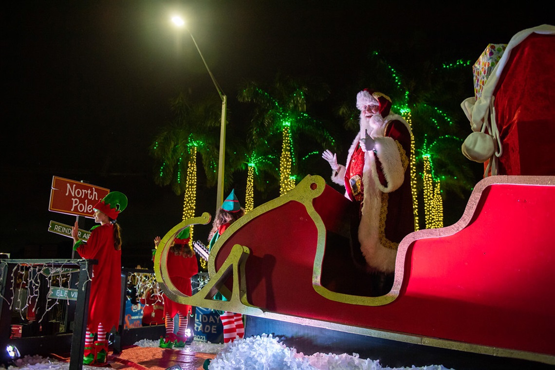 Holiday Parade Santa standng and waving in Santa Sleigh